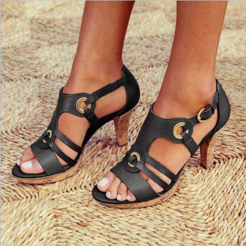 Imogen T bar heeled sandals in black, worn